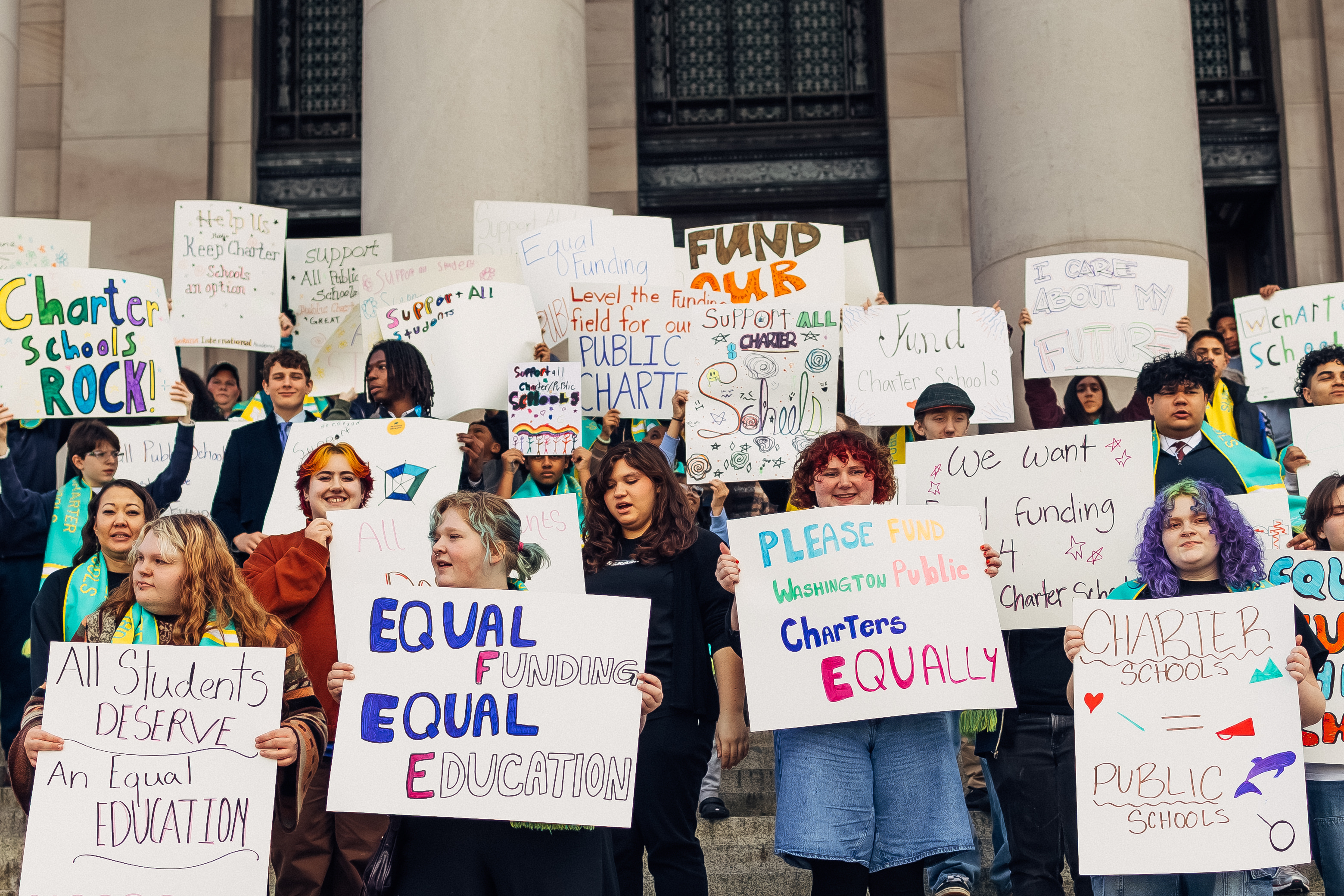Students holding signs in support of charter public schools